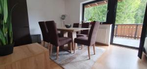 a dining room with a wooden table and chairs at Apartment Alpska Astra in Kranjska Gora