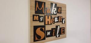 a painting of the words make my heart smile at Apartment Alpska Astra in Kranjska Gora