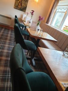 eine Reihe von Tischen und Stühlen in einem Restaurant in der Unterkunft West End Guest House in Kirkwall