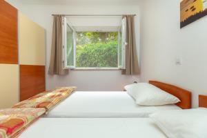 Postel nebo postele na pokoji v ubytování Apartments Vesna