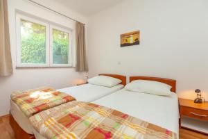 Postel nebo postele na pokoji v ubytování Apartments Vesna