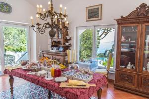 a table with food on it in a room with windows at Suite Villa Carolina in Capri