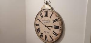 a pocket watch is hanging on a wall at Apartment Alpska Astra in Kranjska Gora