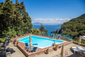 a swimming pool with a view of the mountains at Suite Villa Carolina in Capri