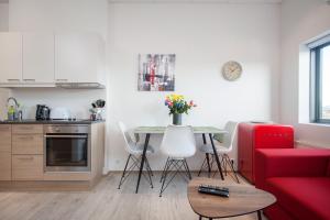 a living room with a red couch and a table at Blue Mountain Apartments by Heimaleiga in Reykjavík