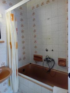 a bathroom with a bath tub and a sink at Hotel Tara in Nyíregyháza