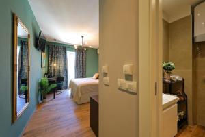 a hotel room with a bed and a bathroom at Aldo Apartments Center in Zadar