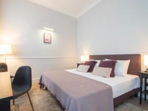 A bed or beds in a room at Holidays Suites Navona