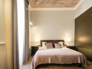 A bed or beds in a room at Holidays Suites Navona