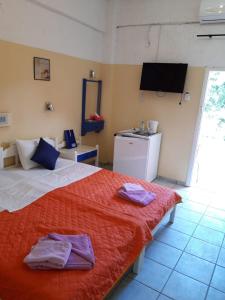 Postel nebo postele na pokoji v ubytování Hotel Neos Matala