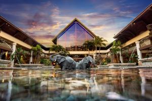 two statues of elephants in front of a building at Universal's Loews Royal Pacific Resort in Orlando