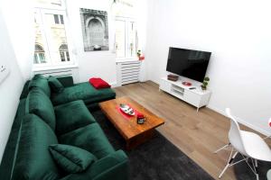 a living room with a green couch and a coffee table at Old Town Luxury Apartments in Sarajevo