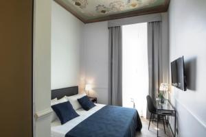 Voodi või voodid majutusasutuse Gemini Suites Navona toas