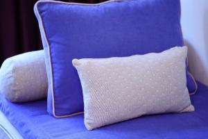 a blue couch with two blue pillows on it at Living In Aparthotel in Oradea