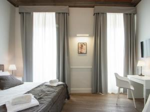Voodi või voodid majutusasutuse Gemini Suites Navona toas
