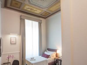 Voodi või voodid majutusasutuse Gemini Suites Navona toas