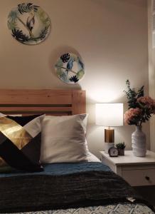 a bedroom with a bed with two plates on the wall at Davao Boutique Condos - Avida in Davao City