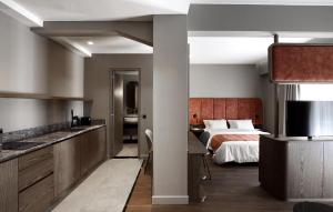 a hotel room with a bed and a kitchen at Roomore Apartments in Thessaloniki