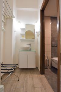 a bathroom with a sink and a toilet at Rodakas Hotel in Akrotiri