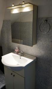 a bathroom with a sink and a mirror at Dream Acropolis Flat in Athens