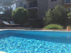 a blue swimming pool in front of a building at Vila Familia Hvar in Vrboska