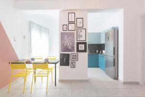 a kitchen with a table and chairs and a refrigerator at #FLH - Belle Reve Apartment in Thessaloniki