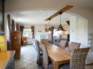 a kitchen and dining room with a wooden table and chairs at Buitenplaats 78 in Callantsoog
