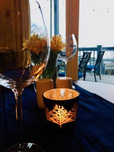 a table with two wine glasses and flowers on it at Treadwell Inn in Saint Andrews