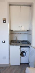 a white kitchen with a sink and a washing machine at ESTUDIO SOLYPLAYARELAX in Fuengirola
