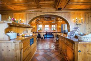 a large kitchen with wooden walls and a large archway at Hotel Oberland in Triesenberg