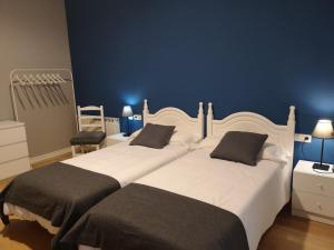 Postel nebo postele na pokoji v ubytování Hostal San Martin