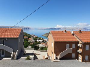 a view of a town with houses and a lake at Slavica apartments 2 in Sveti Juraj