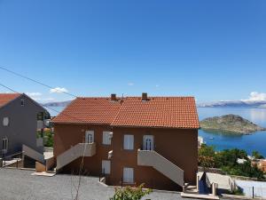 a house with a view of the water at Slavica apartments 2 in Sveti Juraj