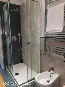 a bathroom with a shower and a white sink at Capozafferano-Casa Carola in Santa Flavia