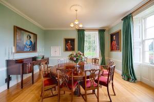 a dining room with a table and chairs at Glamis House in Forfar