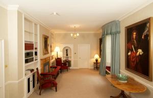 a hallway with a living room with a table and chairs at Glamis House in Forfar