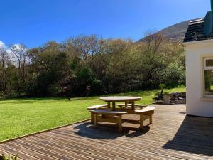 a picnic table and a bench on a deck at Victoria's house in Kells