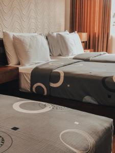 two beds sitting next to each other in a room at Pinnacle boutique villas in Galle