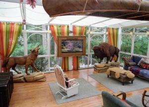 uma sala de estar cheia de móveis e estátuas animais em Canada Lodge Campos do Jordão em Campos de Jordão