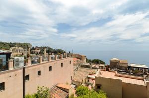 
a large building with a lot of windows on top of it at Sweet Taormina Apartment in Taormina
