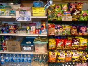 a grocery store shelf filled with different types of food at Dragon Pearl Beach Resort in Kota Belud