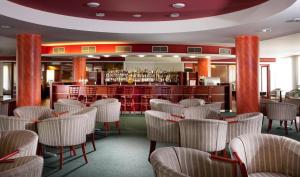 a restaurant with chairs and a bar in the background at LIPNO WELLNESS - FRYMBURK C112 private family room in Frymburk
