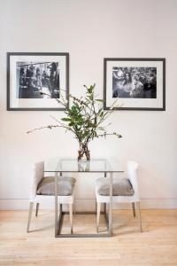 a dining room with a glass table and two chairs at No.5 Maddox Street in London