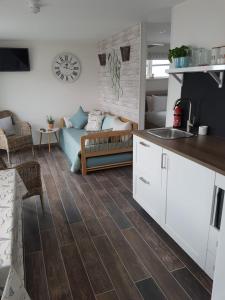 a kitchen and living room with a couch at Dunseverick Ramblers Rest in Bushmills