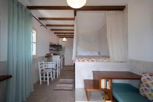 a small room with a bunk bed and a table at Studios Aeolos Kalymnos in Myrties