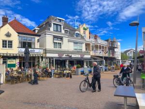 a group of people with bikes on a city street at Church Square Studio in Zandvoort
