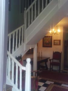 a staircase in a house with a table and a stair case at Casa de Aldea la Galeria habitación en casa particular in poo de Llanes