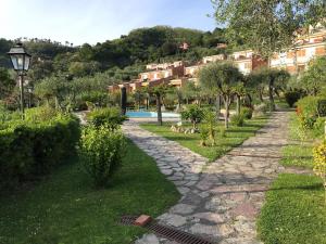 a stone path in a garden with a resort at La Casa fra gli ulivi in Lerici