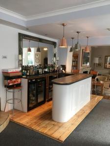 a bar in the middle of a room at Penryn House Hotel in Polperro +21 photos