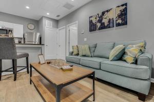 a living room with a blue couch and a table at New 1/1 :Loft Minutes From Heart of Tampa -Unit C in Tampa